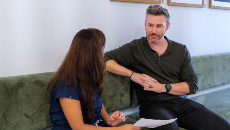 A veteran having a consultation with a healthcare professional in a modern clinic to discuss his healthcare pathway and care plan.