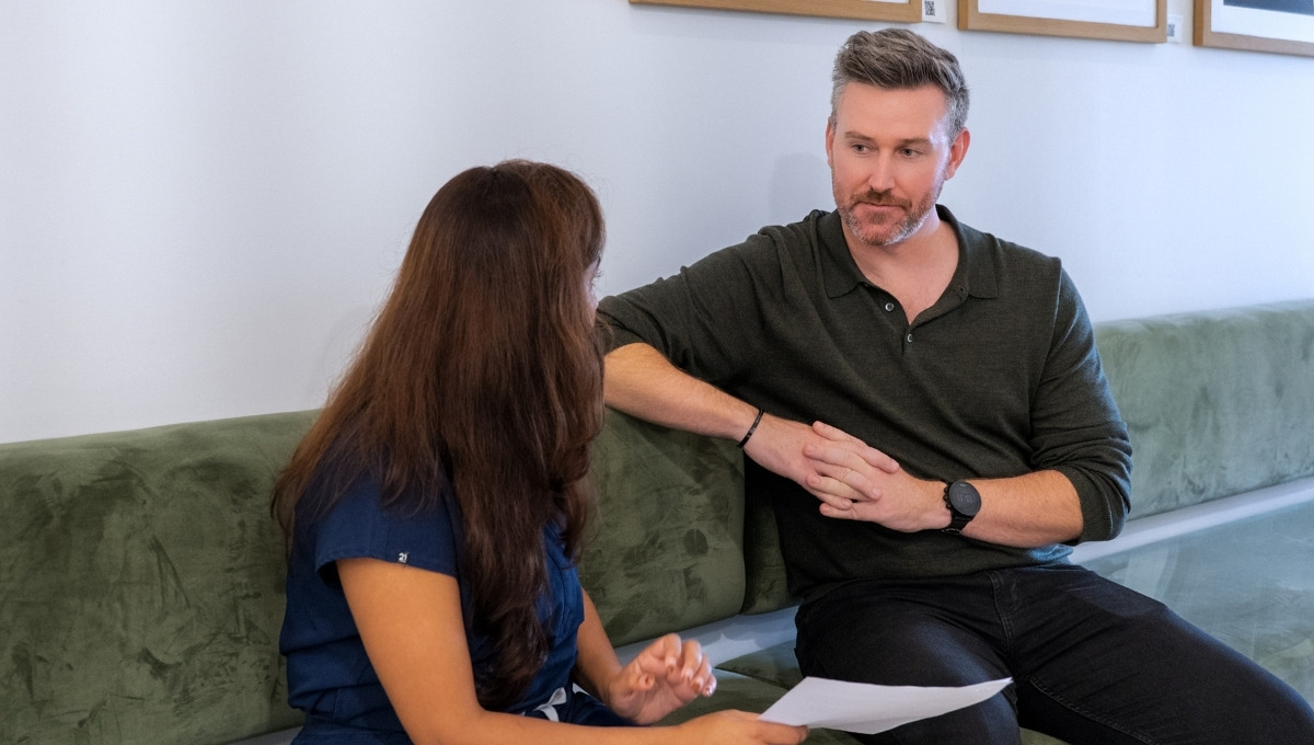 A veteran having a consultation with a healthcare professional in a modern clinic to discuss his healthcare pathway and care plan.