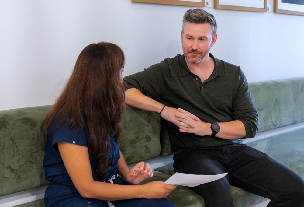 A veteran having a consultation with a healthcare professional in a modern clinic to discuss his healthcare pathway and care plan.