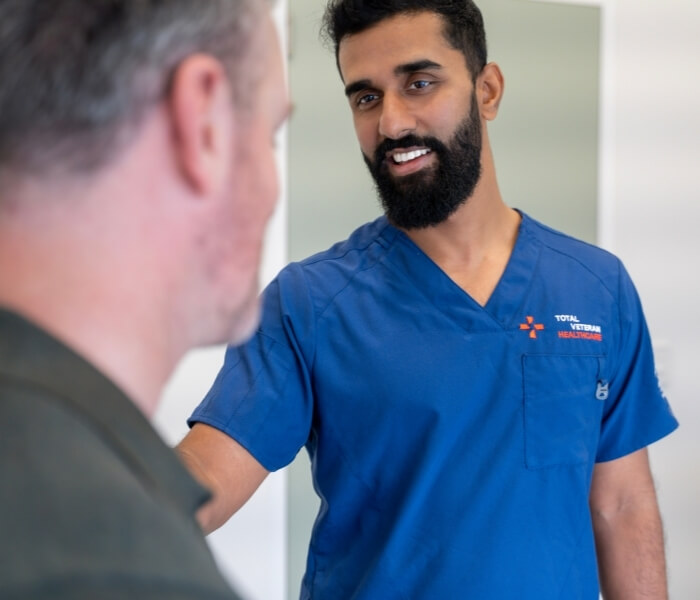 Total Veteran Healthcare psychiatrist speaking with a patient during a consultation